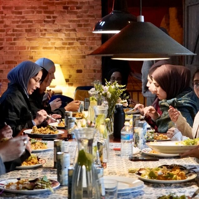 Muslim women eating dinner at the Ta Collective retreat