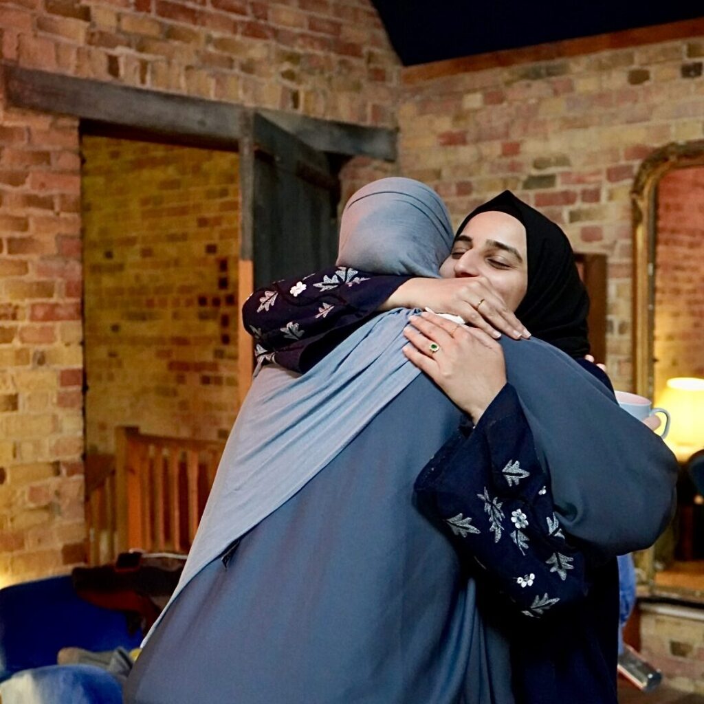 Muslim women hugging at a retreat